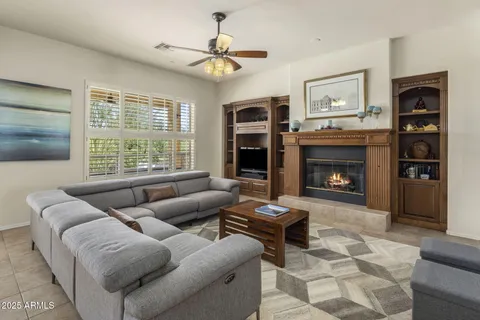 a living room with furniture a window and a fireplace