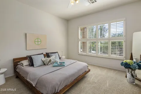 a bedroom with a bed and window