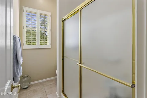 a bathroom with a glass shower door