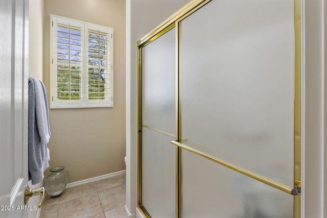 a bathroom with a glass shower door