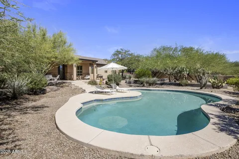 a view of a swimming pool with a yard