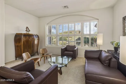 a living room with furniture and a floor to ceiling window