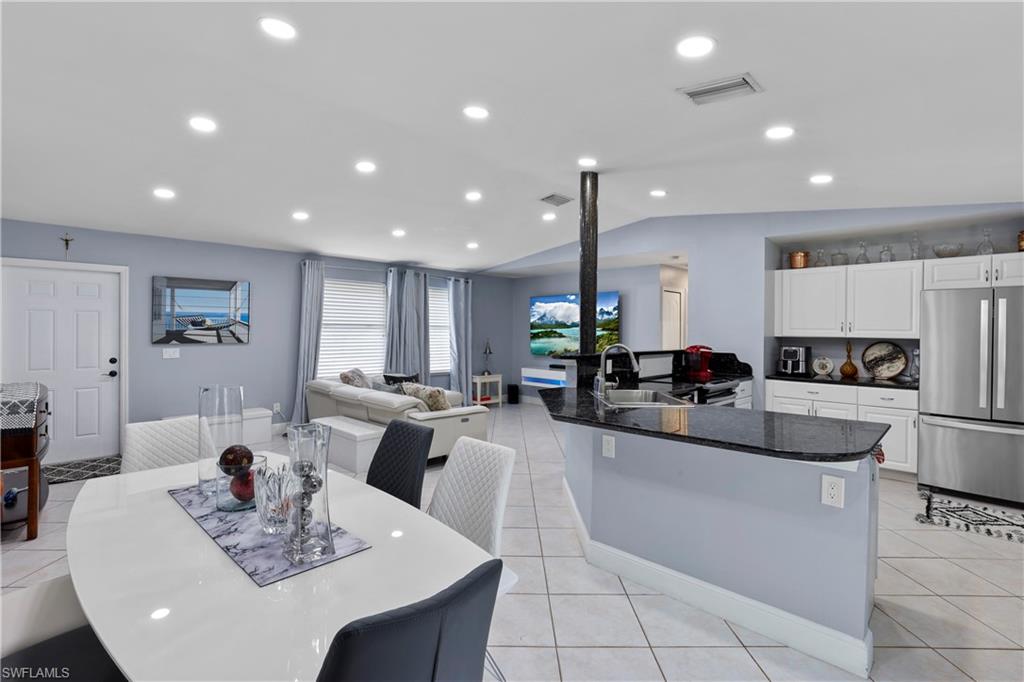 a large kitchen with a table and chairs