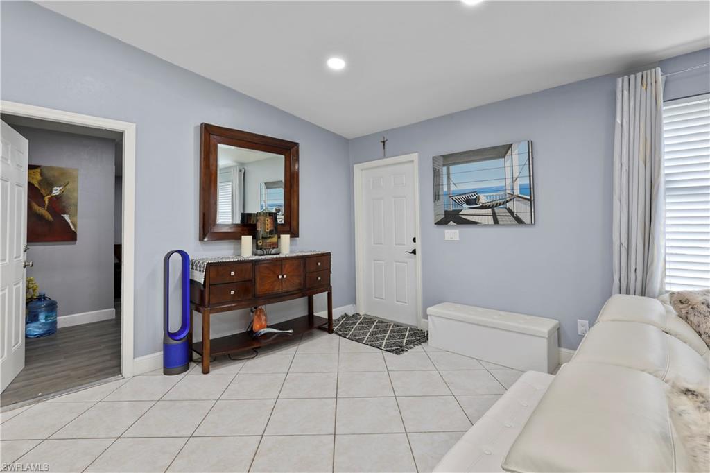 4641 Pine Ridge Road Naples, FL 34119 - Photo 11 of 30 a bedroom with furniture and a window