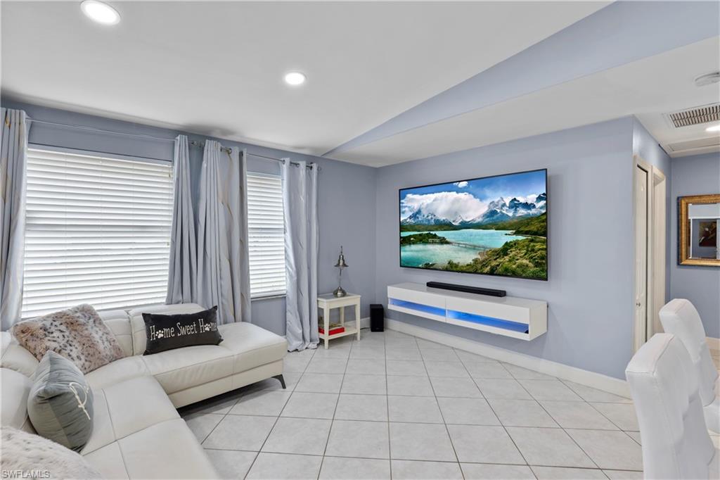 4641 Pine Ridge Road Naples, FL 34119 - Photo 13 of 30 a living room with furniture and a flat screen tv