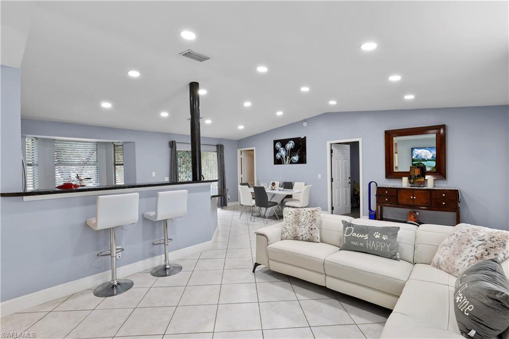 4641 Pine Ridge Road Naples, FL 34119 - Photo 14 of 30 a living room with furniture and a flat screen tv