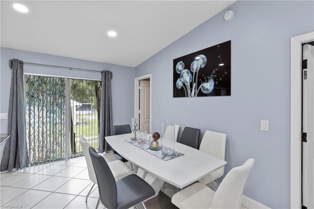4641 Pine Ridge Road Naples, FL 34119 - Photo 15 of 30 a view of a dining room with furniture window and outside view