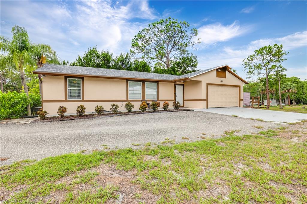 4641 Pine Ridge Road Naples, FL 34119 - Photo 2 of 30 a view of a house with a yard and potted plants