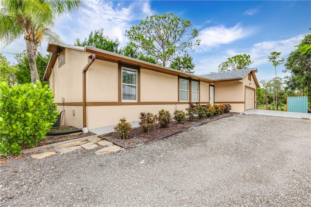 4641 Pine Ridge Road Naples, FL 34119 - Photo 22 of 30 a backyard of a house with lots of green space