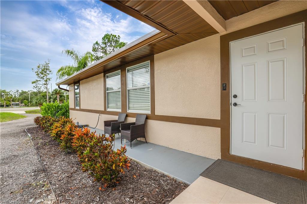 4641 Pine Ridge Road Naples, FL 34119 - Photo 23 of 30 a very nice looking house with a large window