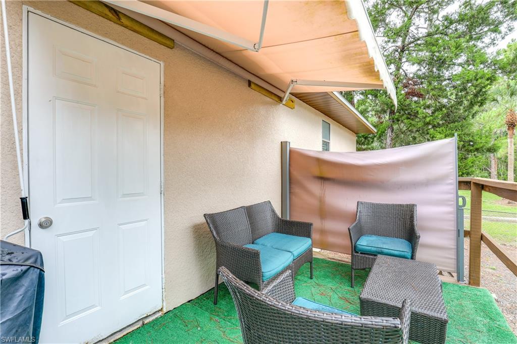 4641 Pine Ridge Road Naples, FL 34119 - Photo 24 of 30 a patio with table and chairs
