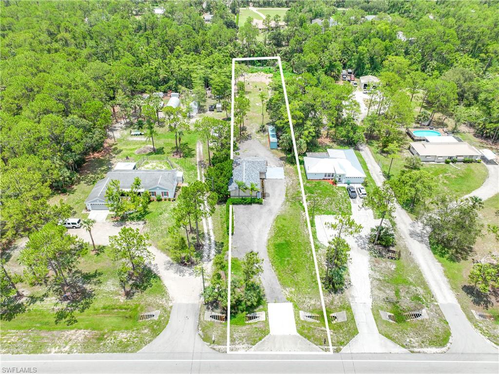4641 Pine Ridge Road Naples, FL 34119 - Photo 25 of 30 an aerial view of a residential houses with yard