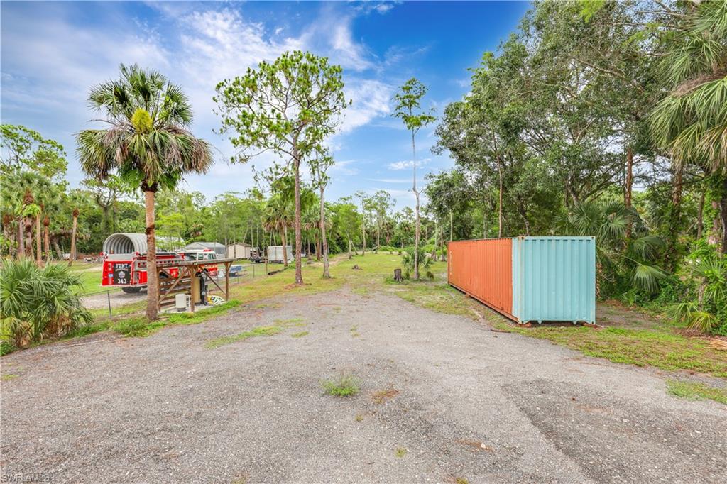 4641 Pine Ridge Road Naples, FL 34119 - Photo 28 of 30 a view of backyard with small play house and slide