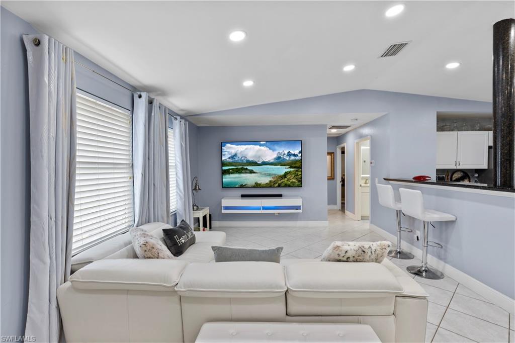 4641 Pine Ridge Road Naples, FL 34119 - Photo 4 of 30 a living room with furniture and a flat screen tv
