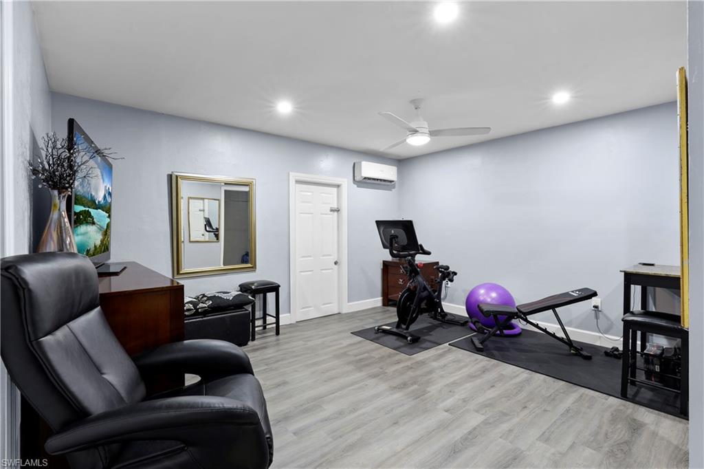 4641 Pine Ridge Road Naples, FL 34119 - Photo 5 of 30 a living room with furniture a flat screen tv and a window