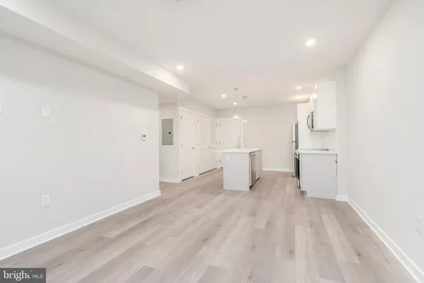 a view of a kitchen with wooden floor
