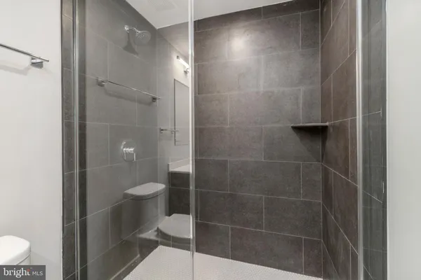 a bathroom with a toilet and a shower