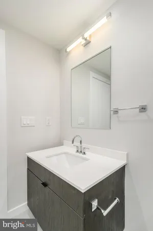 a bathroom with a sink vanity and a mirror