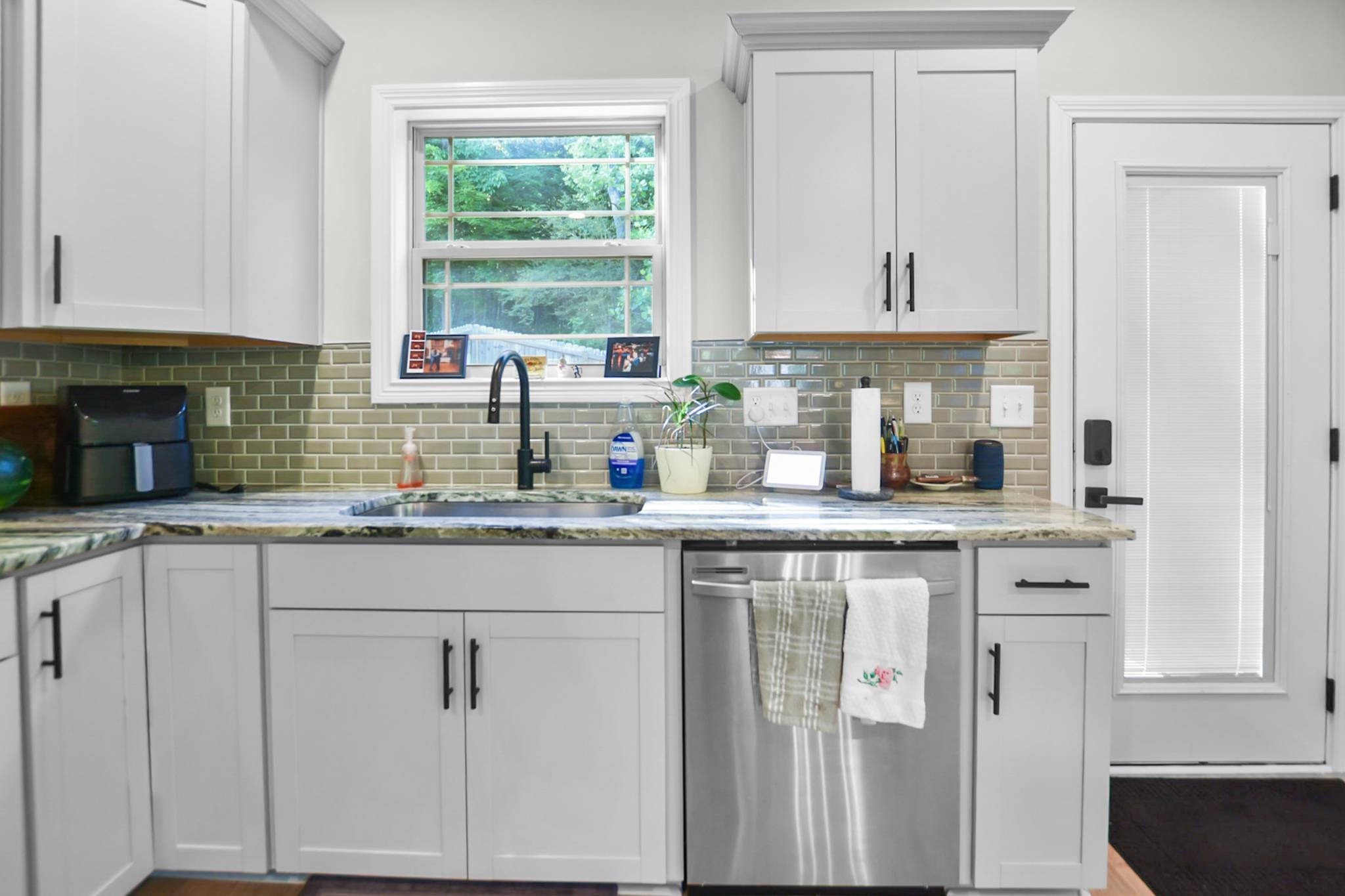 60 Cave Springs Road, Unit B Clarksville, TN 37042 - Photo 8 of 16 a kitchen with stainless steel appliances granite countertop white cabinets sink and window