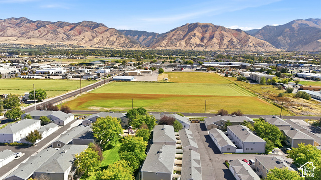 108 Penhurst Place Logan, UT 84341 - Photo 42 of 44 Aerial perspective featuring multi-unit properties and extensive green spaces with a mountain backdrop