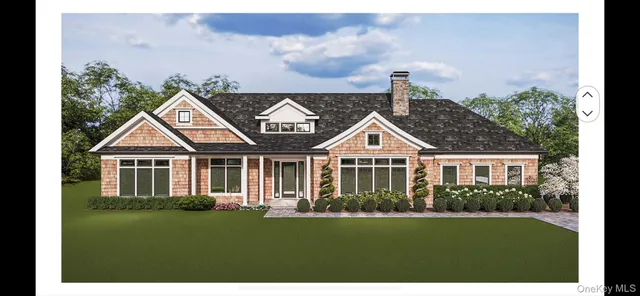 a front view of a house with a yard and potted plants