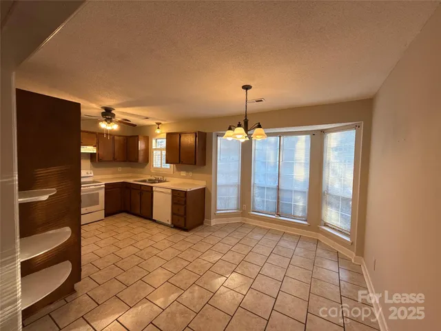 a view of a kitchen with a sink and a stove top oven