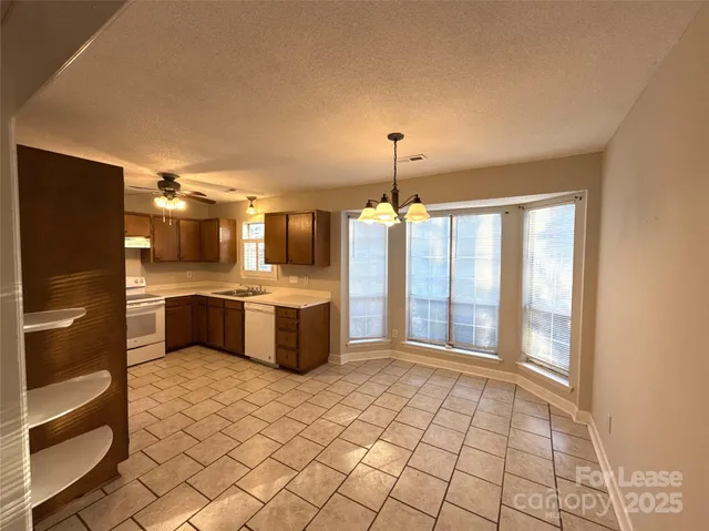 a large kitchen with a large window and stainless steel appliances