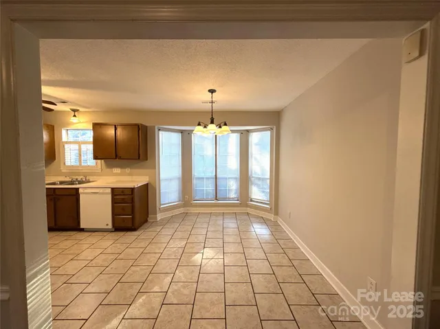 a view of a kitchen with a sink and a stove top oven