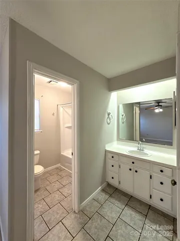 a bathroom with a glass door shower a sink and a mirror