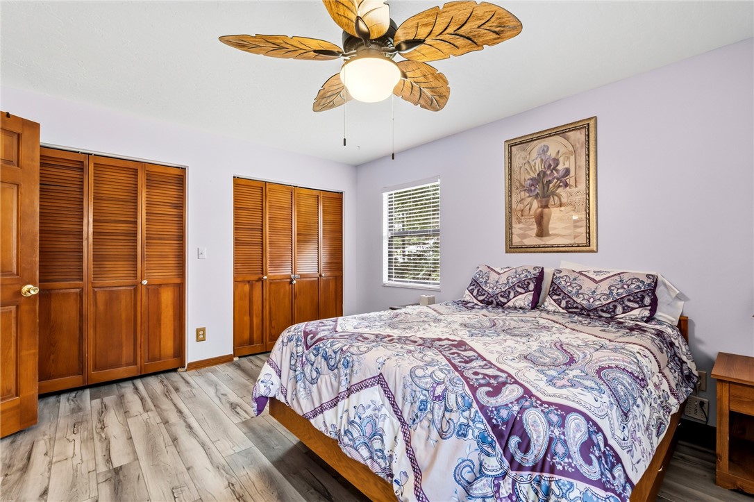 831 Clearmont Street Sebastian, FL 32958 - Photo 20 of 24 a bedroom with a large bed closet and flat screen tv
