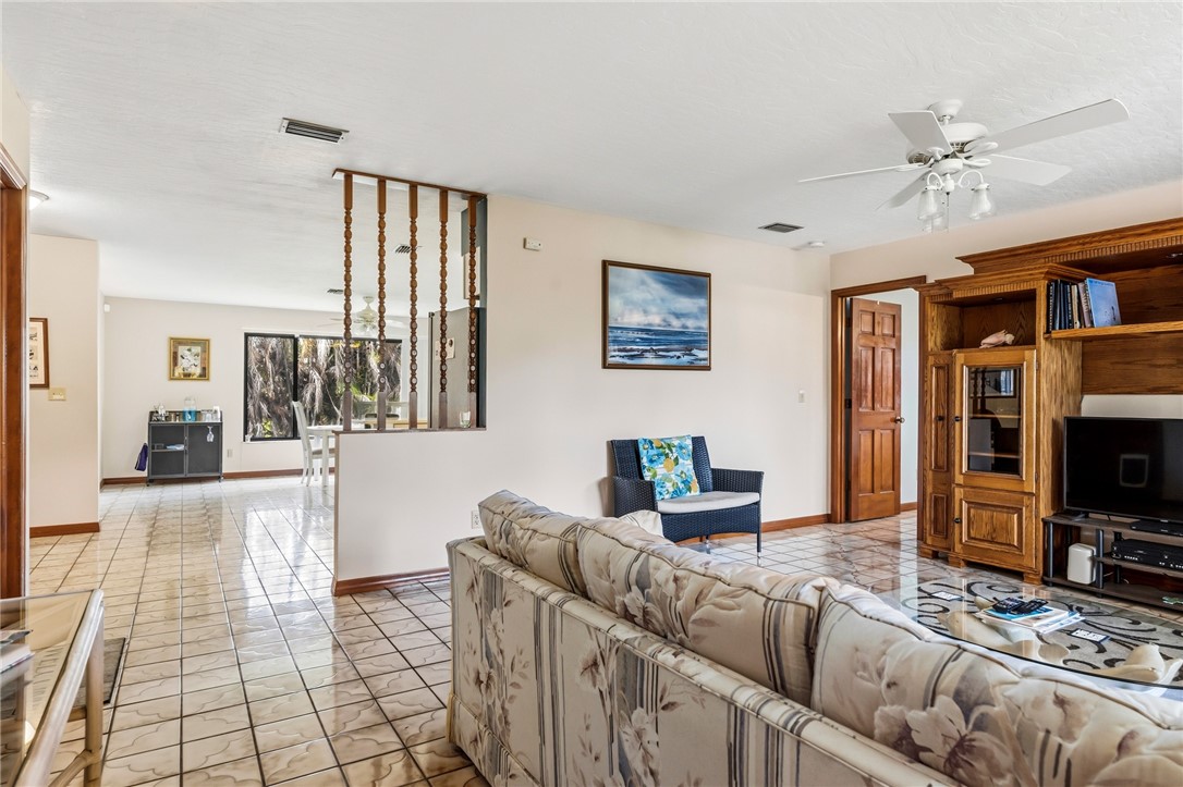 831 Clearmont Street Sebastian, FL 32958 - Photo 6 of 24 a living room with furniture and a flat screen tv