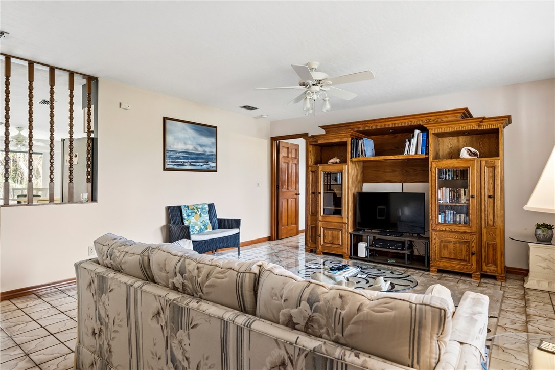 831 Clearmont Street Sebastian, FL 32958 - Photo 7 of 24 a living room with furniture a flat screen tv and a fireplace