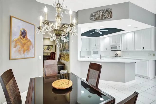 a kitchen with stainless steel appliances granite countertop a sink dishwasher and white cabinets with wooden floor