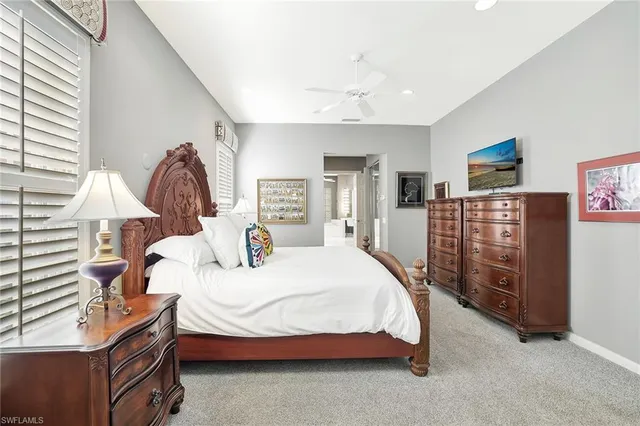 a bedroom with a bed and dresser with mirror