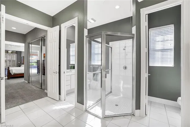 a bathroom with a glass shower door and a glass door shower