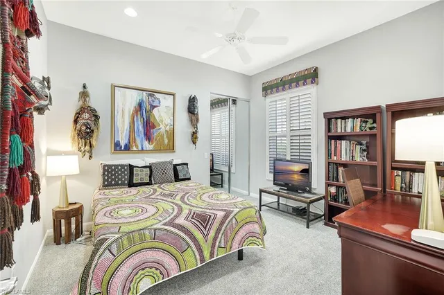 a bedroom with a bed furniture and a large window