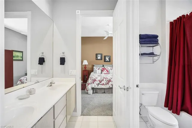 a en suite bathroom with a sink double vanity and toilet