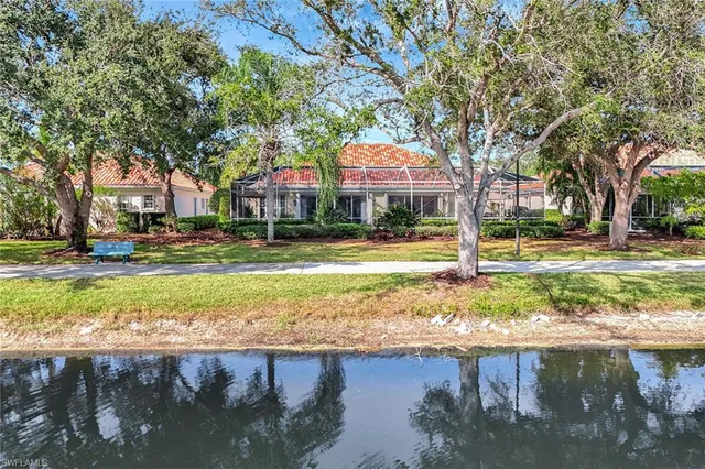 a front view of a house with a yard and fountain