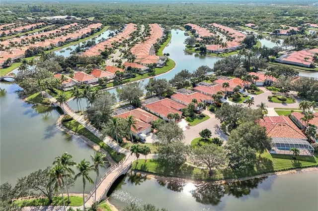 an aerial view of lake and residential houses with outdoor space