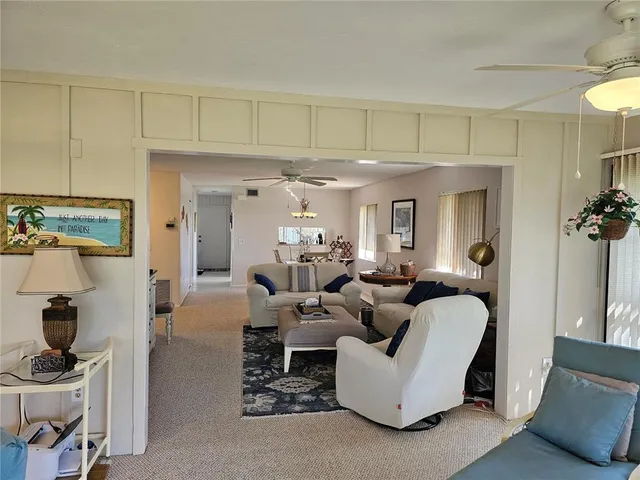 a bedroom with bed and paintings on the wall