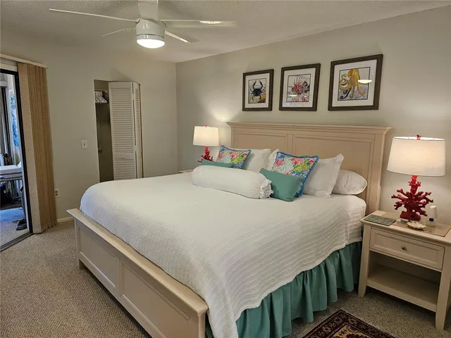 a bedroom with a bed and a large mirror