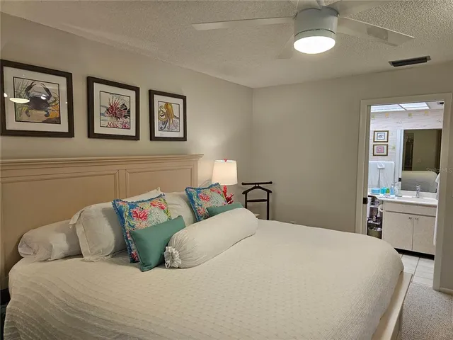 a bedroom with a bed and a television