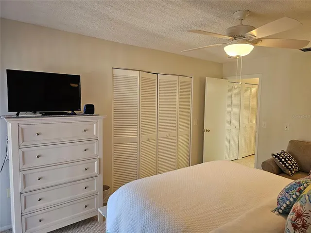 a bedroom with a bed and a painting on the wall