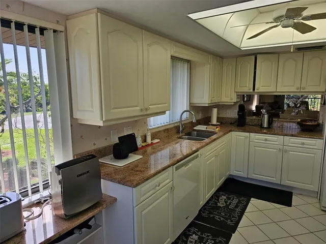 a kitchen with a sink a stove and a window