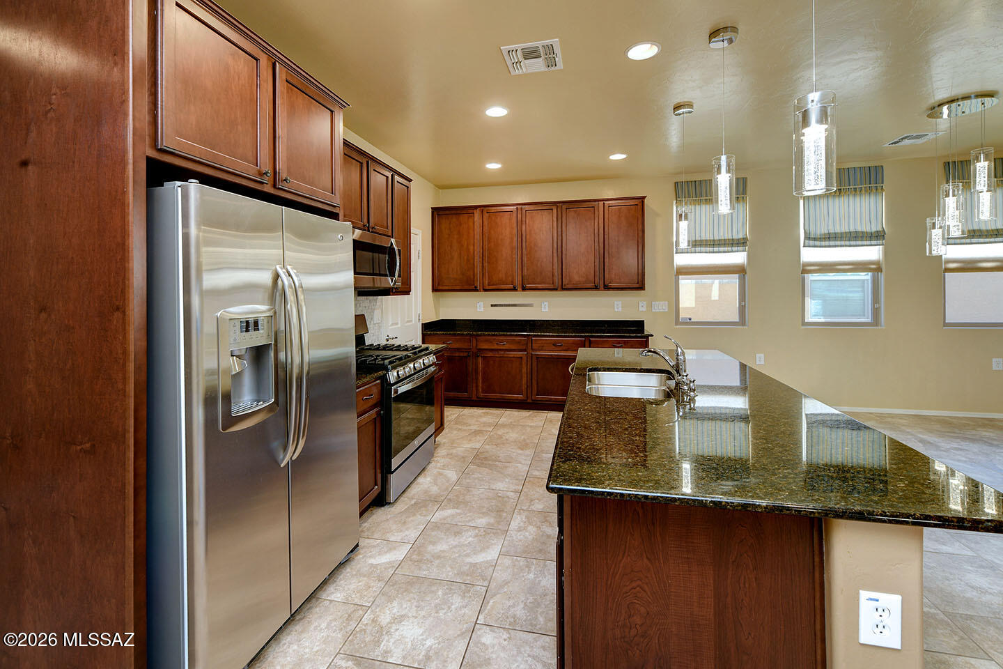 13991 East Cheavront Loop Vail, AZ 85641 - Photo 6 of 47 a kitchen with stainless steel appliances granite countertop a refrigerator a sink and a stove