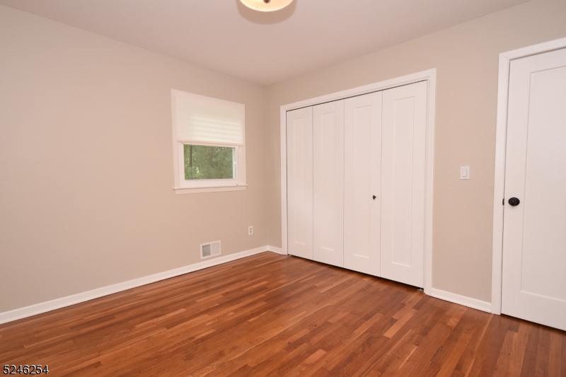 511 Scotland Road South Orange, NJ 07079 - Photo 14 of 26 an empty room with wooden floor and windows