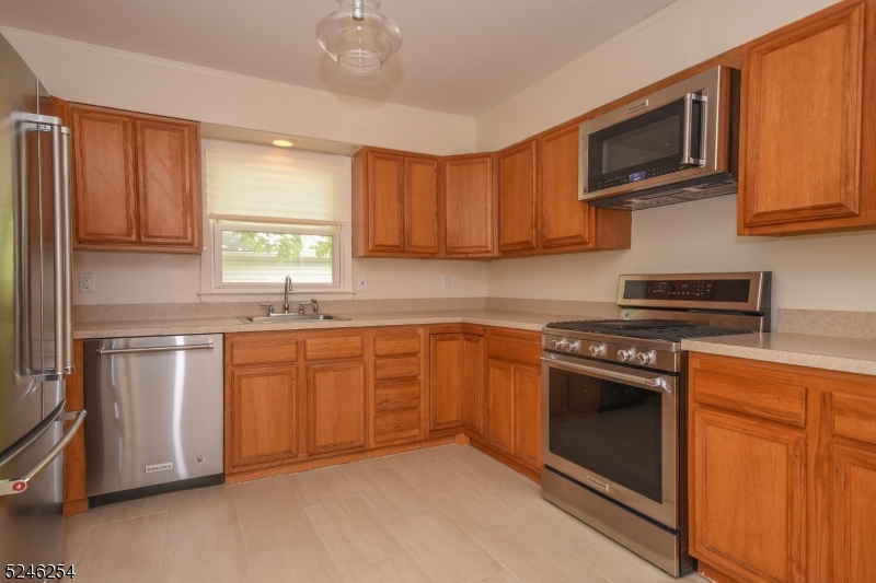 511 Scotland Road South Orange, NJ 07079 - Photo 8 of 26 a kitchen with stainless steel appliances granite countertop a sink a stove a microwave and cabinets
