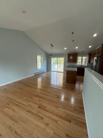 a view of kitchen and hall with wooden floor