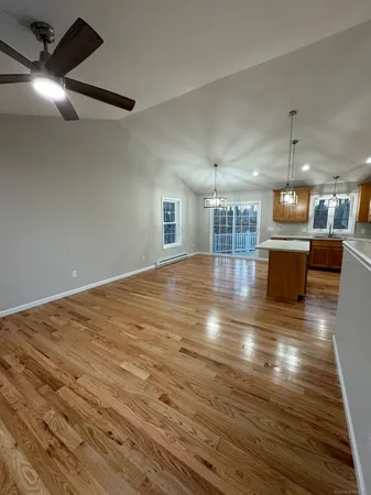 a view of kitchen and hall with wooden floor