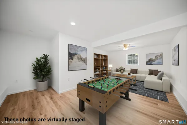 a living room with furniture and a potted plant